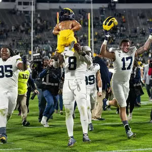 Football Celebrating With Paul Bunyan Trophy