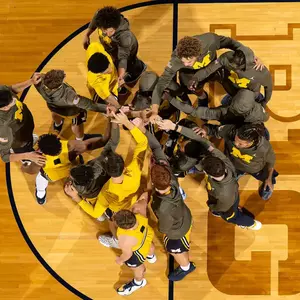 Men's basketball team huddle