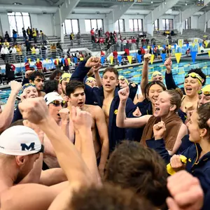Men's and women's team huddle