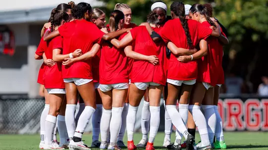 The Georgia soccer team huddles before its exhibition against Auburn on August 5.