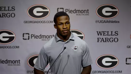 Kyron Jones standing at podium for Football Media Day Press Conference