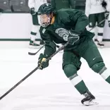 Chase Reid handles the puck during Michigan State hockey practice