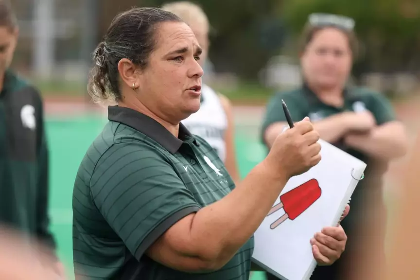 Tamara Durante speaks to the team on the sidelines