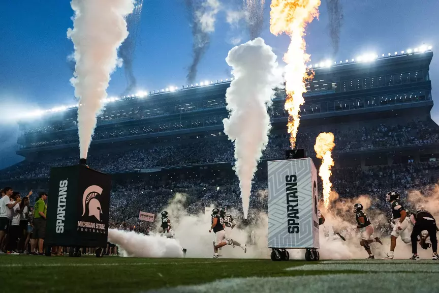 Michigan State runs out of the tunnel in the season opener vs. Toledo.