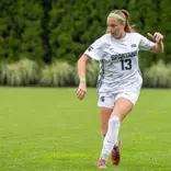 LJ Pearcy moves the ball forward in a rainy game vs. Michigan