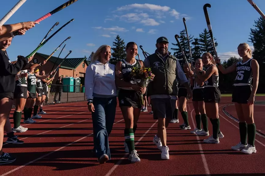 Bianca Pizano walks with her family during the senior celebration