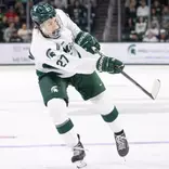 Chase Reid shoots the puck against Boston College