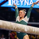 Isabella Trostel finishes a beam routine at the Big Ten Championships