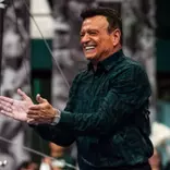 Michigan State head gymnastics coach Mike Rowe celebrates after a routine