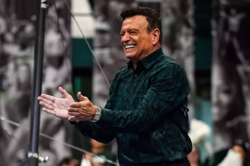 Michigan State head gymnastics coach Mike Rowe celebrates after a routine
