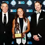 Maddie Lawlor is presented with the national Jackie Robinson Award by Big Ten Commissioner Tony Petitti and J Batt at the MSU Academic Gala