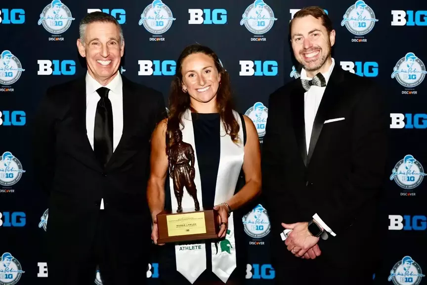 Maddie Lawlor is presented with the national Jackie Robinson Award by Big Ten Commissioner Tony Petitti and J Batt at the MSU Academic Gala