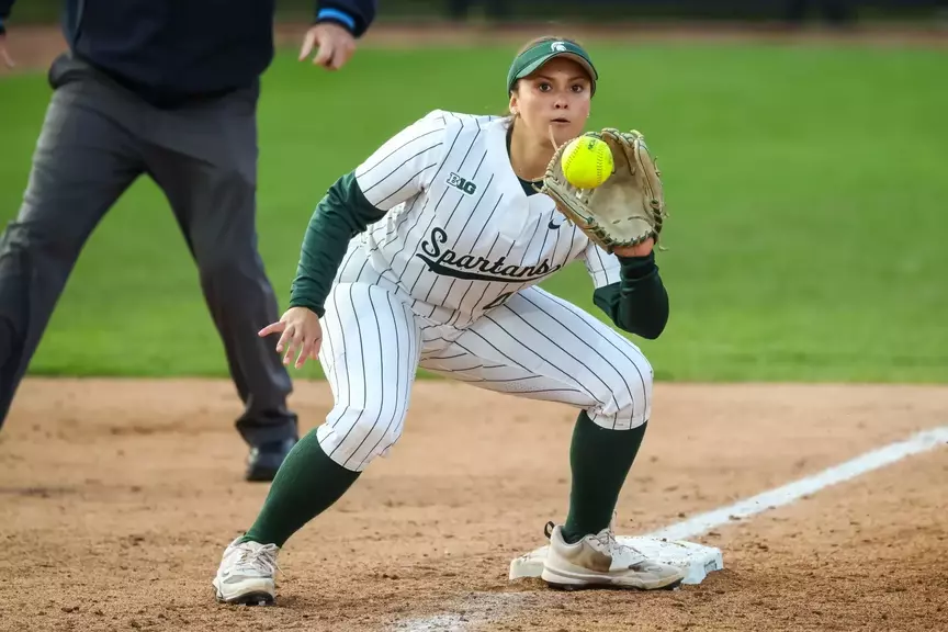 Hannah Hawley catches the ball at third base to apply the tag on a stealing runner against Illinois