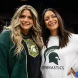 MSU gymnastics coaches Nicole Jones and Devin Wright stand for a photo