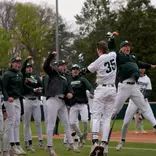 Randy Seymour and Josh Klug celebrate with the dugout after Seymour hit a home run.