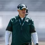 Pat Fitzgerald walks the field during a spring practice in Spartan Stadium.