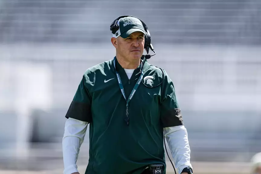 Pat Fitzgerald walks the field during a spring practice in Spartan Stadium.