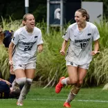 Ella Janz and Emerson Sargeant celebrate a goal against Michigan