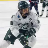 Ryker Lee controls the puck near the boards against UConn in the NCAA Tournament