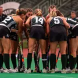 The Michigan State field hockey team huddles on the field