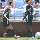 Kayla Briggs and Kennedy Bell celebrate a goal at North Carolina