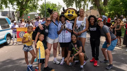 CU Women's Basketball student-athletes and staff members strike a pose as they finish the 2021 Juneteenth Parade in historic Five Points.