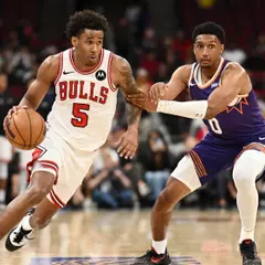 CHICAGO, ILLINOIS - OCTOBER 07: Dailyn Swain #5 of the Chicago Bulls dribbles the ball as Ryan Dunn #0 of the Phoenix Suns defends during the second half of the preseason game at the United Center on October 07, 2026 in Chicago, Illinois. NOTE TO USER: User expressly acknowledges and agrees that, by
