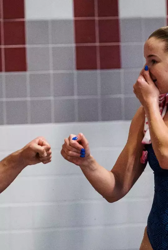 Forester and Kupka fist bumping during the NCAA Zone D Diving Championships