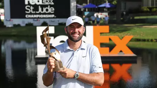 MEMPHIS, TENNESSEE - AUGUST 16: Scottie Scheffler of the United States celebrates with the trophy after winning during the final round of the FedEx St. Jude Championship 2026 at TPC Southwind on August 16, 2026 in Memphis, Tennessee. (Photo by Stacy Revere/Getty Images)