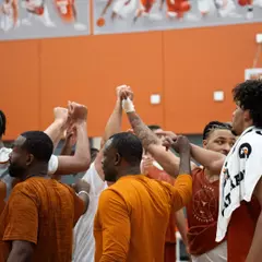 men's basketball end of practice team huddle image
