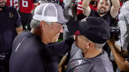 Keith Patterson shakes hands with Joey McGuire following ACU's 52-51 loss at Texas Tech on August 31, 2024