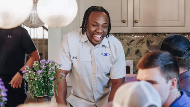 Anthony Egbo laughs with ACU football fans during an event on April 16, 2025