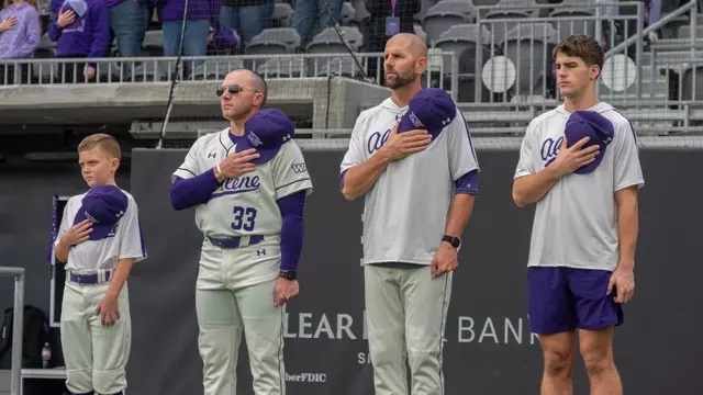 ACU baseball coaches Blaze Lambert and Rick McCarty stand for the national anthem before an opening series game vs. St. Thomas in Feb. 2026