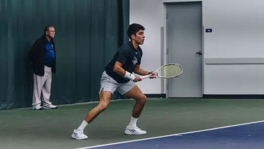 Luis Jose Nakamine prepares to return the ball to his opponent.