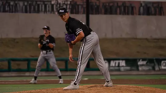 Noah Galvan checks a runner at first base in ACU's matchup with Texas State in Cleburne, Texas on March 1, 2026.