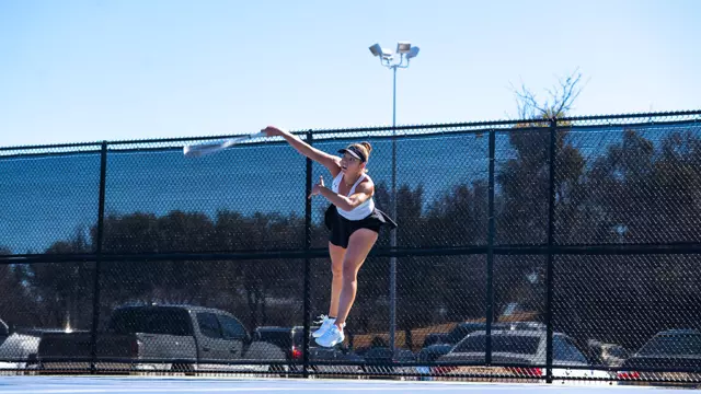 Masha Vrsalovic jumps in the air to return a ball in her match against Texas State on Feb. 15.