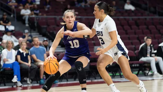 Payton Hull drives in against a California Baptist defender during the 2026 WAC Tournament championship game on March 14, 2026