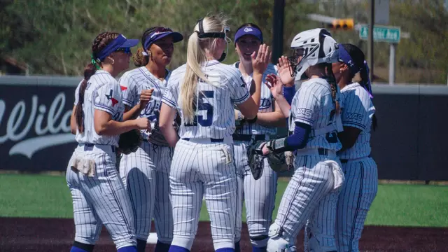 ACU softball players huddle up during a game against UT Arlington on March 20, 2026