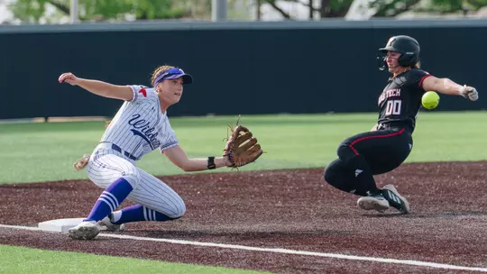 Emalee Romero slides to catch the softball and tag out a Texas Tech runner attempting to steal third base on March 31, 2026
