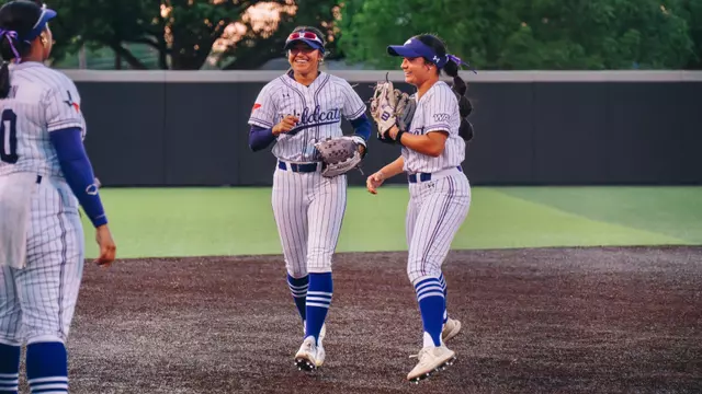 Julianna Martinez and Kyana Lipardo smile as they run off the field during a game against North Texas on April 15, 2026