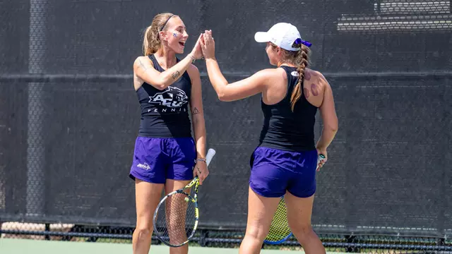 Alice Klinteby and Jess Board celebrate after winning a doubles point on April 1, 2026 against UT Arlington.