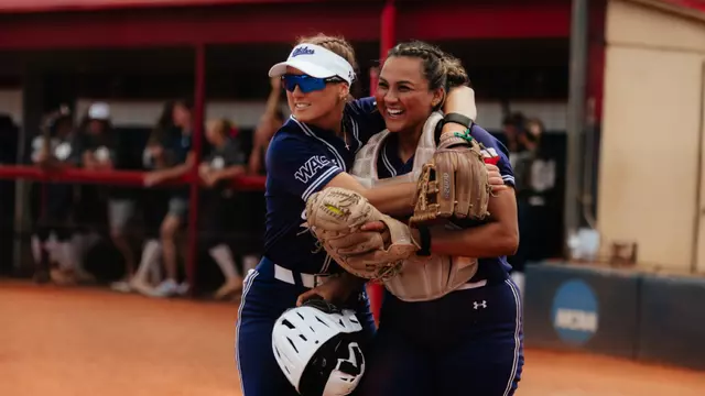 Emalee Romero hugs catcher Valerie Ornelas after an impressive catch in foul territory during a game at Utah Tech on May 1, 2026