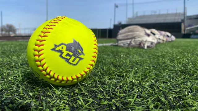 ACU softball with gloves in background