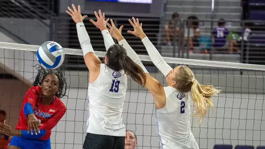 Maddie Finnegan and Avery Thaler attempt to block an attack in ACU's 3-0 win over Louisiana Tech at Moody Coliseum on Sept. 17, 2026.