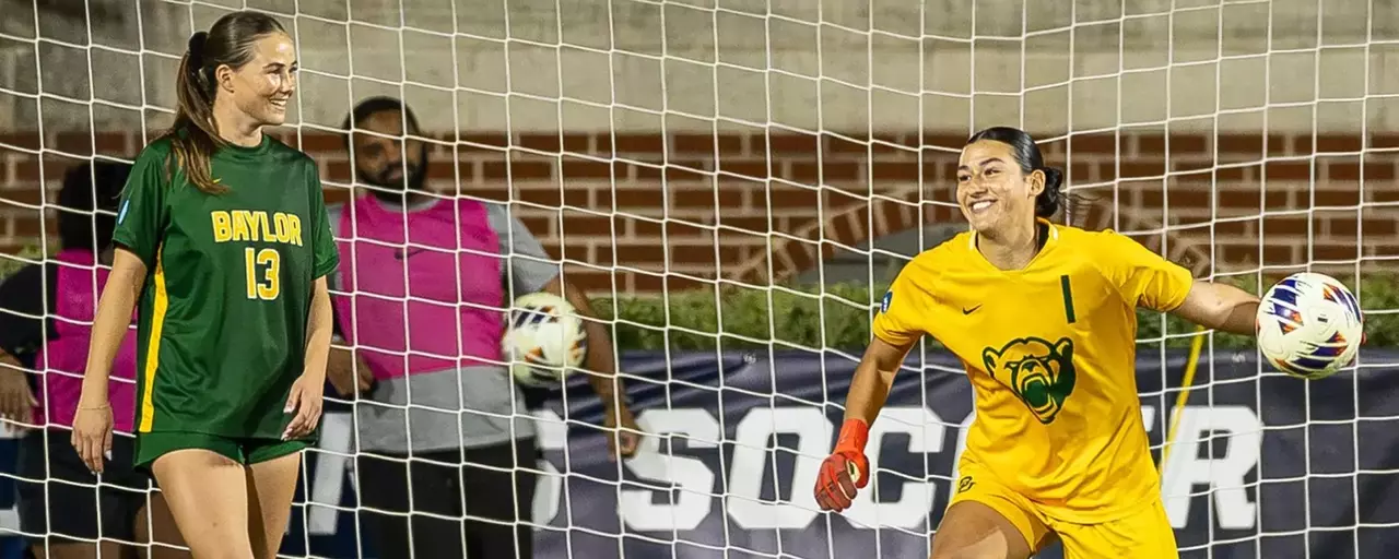 Soccer players Azul Alvarez and Blythe Obar smile after Alvarez makes another save in BU's win over Texas State