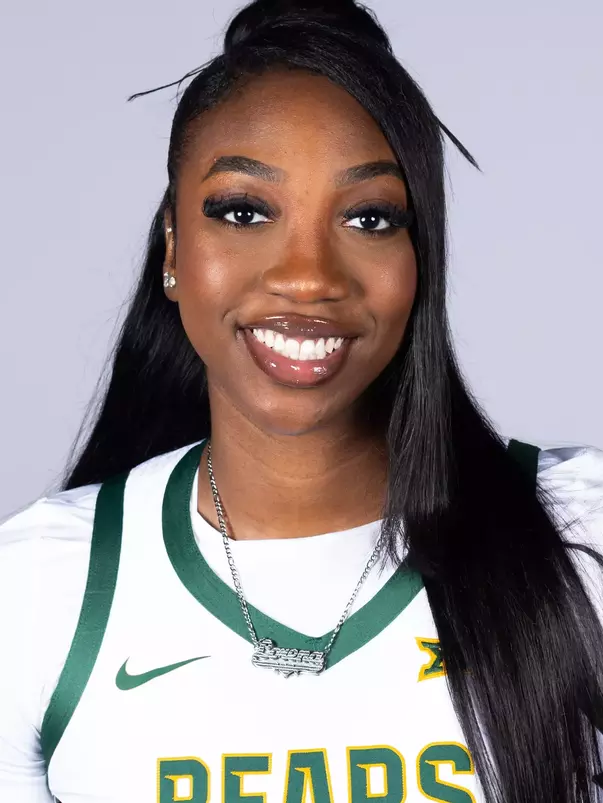 Lorena Awou headshot in white uniform in front of white backdrop