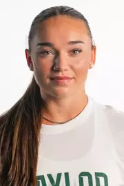 Bella Basson smiling in headshot in front of white backdrop