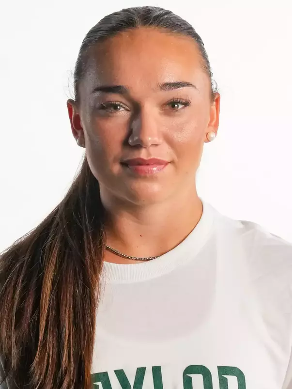 Bella Basson smiling in headshot in front of white backdrop