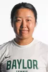 Na Dong smiling in headshot in front of white backdrop