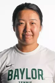Na Dong smiling in headshot in front of white backdrop